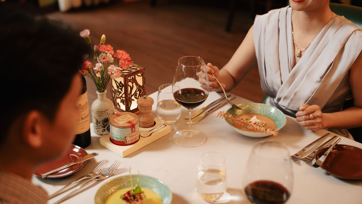 A beautifully plated Michelin-selected French dish being served during a luxury birthday celebration dinner at The Temptation restaurant in Da Nang